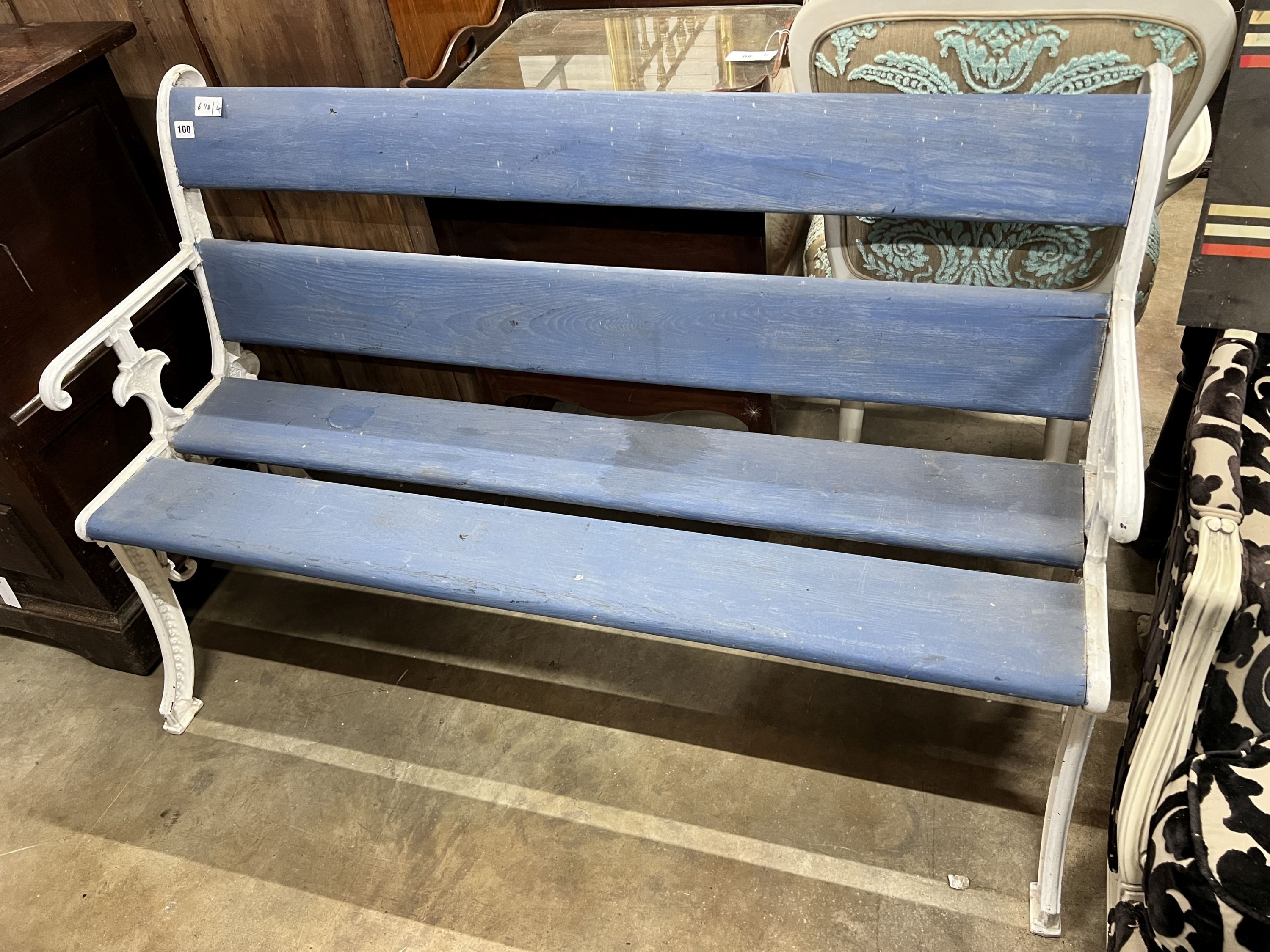 A Victorian style painted cast iron and wooden slatted garden bench, length 131cm, depth 54cm, height 84cm